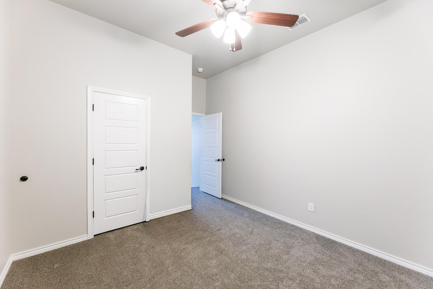 7619 59th Street Lubbock, TX 79407 - Photo 26 of 33 an empty room with closet and a chandelier fan