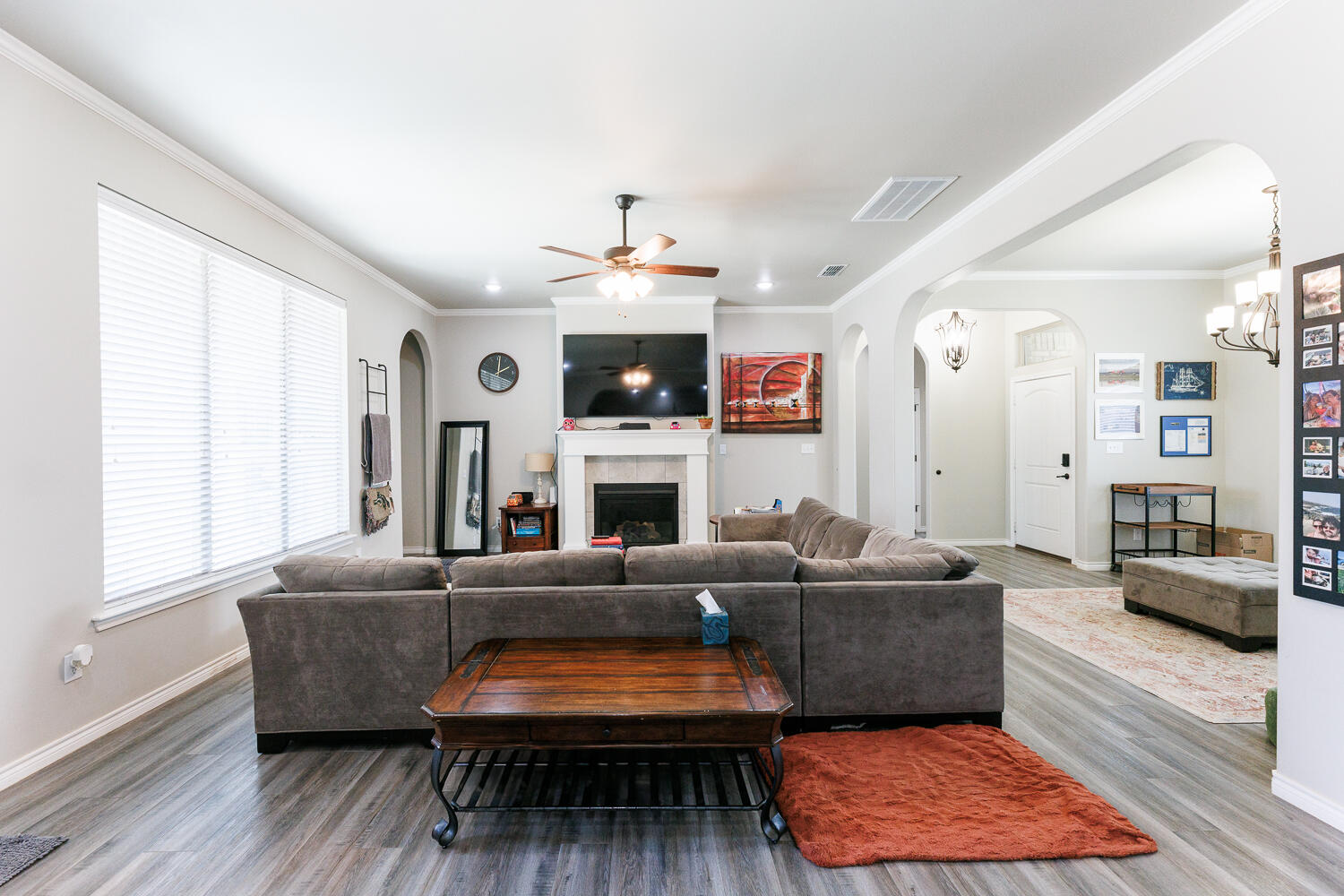 7619 59th Street Lubbock, TX 79407 - Photo 8 of 33 a living room with furniture a fireplace and a large window