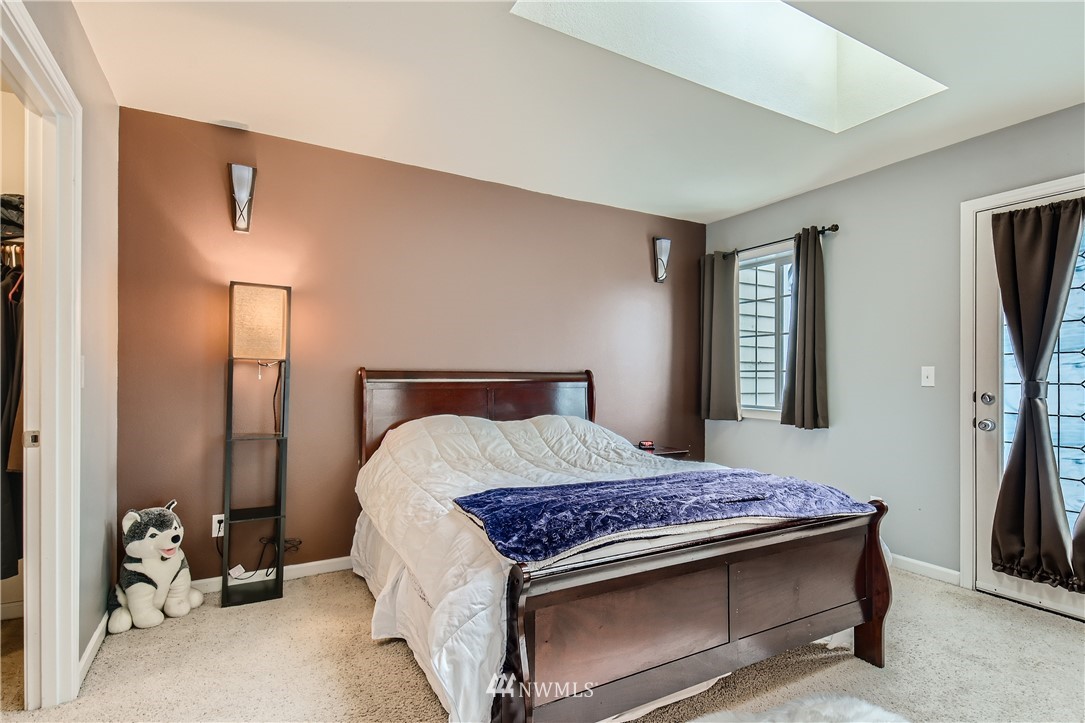 2750 Diamond Loop, Unit E Milton, WA 98354 - Photo 7 of 13 a bedroom with a bed and a flat tv screen on the dresser