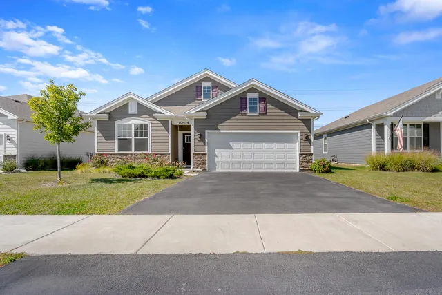 a front view of a house with a yard and garage