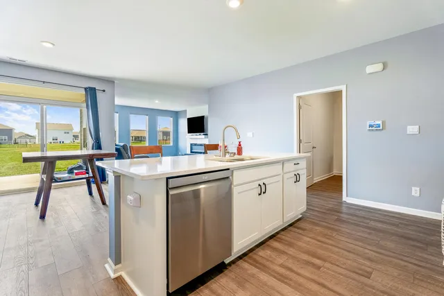 a kitchen with refrigerator cabinets dining table and chairs