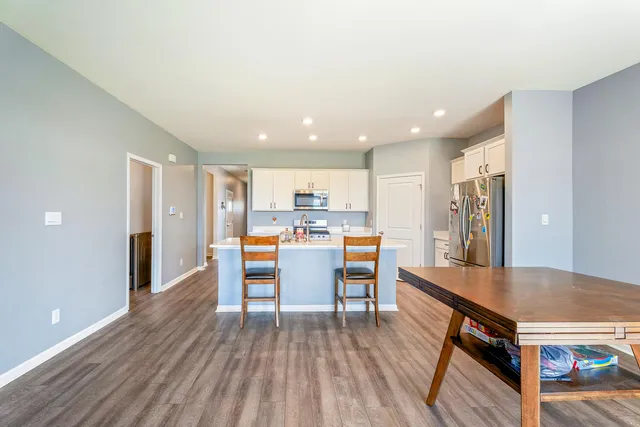 a view of a kitchen with dining table and chairs