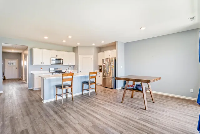 a living room with furniture and a table chair