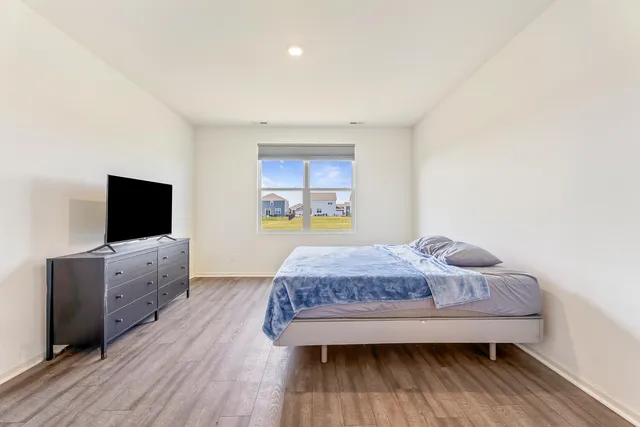 a bedroom with a bed and window