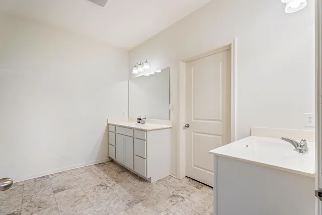a bathroom with a double vanity sink and mirror