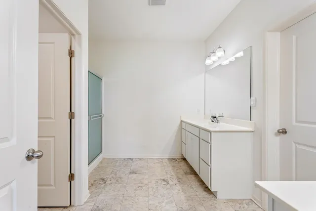 a view of walk in closet with clothes