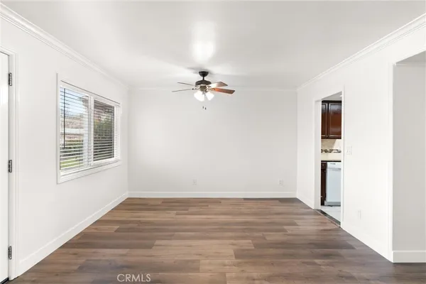 a view of a room with a ceiling fan and a window