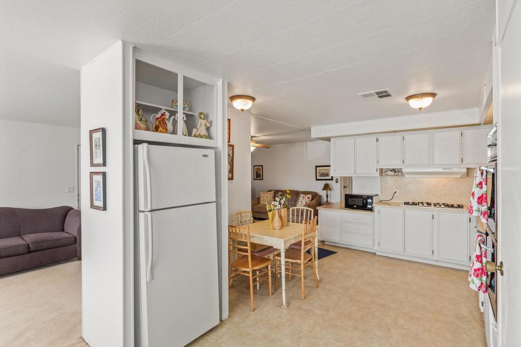650 South Rancho Santa Fe Road, Unit 256 San Marcos, CA 92078 - Photo 11 of 60 a white refrigerator freezer sitting in a kitchen