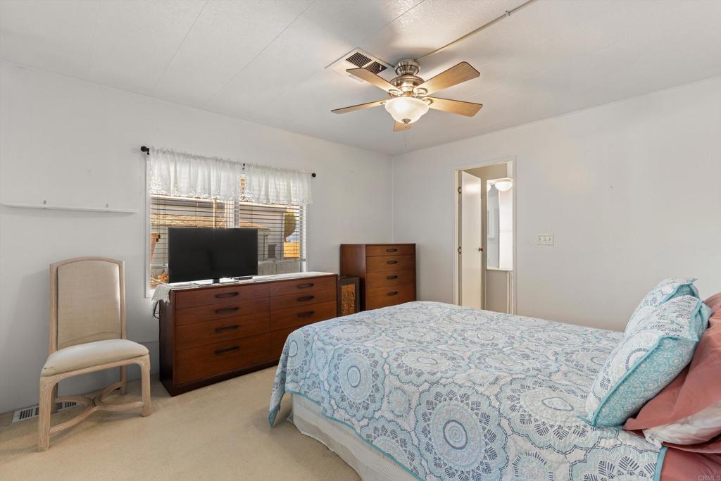 650 South Rancho Santa Fe Road, Unit 256 San Marcos, CA 92078 - Photo 17 of 60 a bedroom with a bed and a flat screen tv