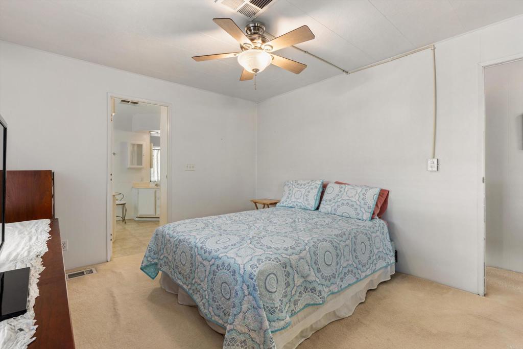 650 South Rancho Santa Fe Road, Unit 256 San Marcos, CA 92078 - Photo 19 of 60 a bedroom with a bed and a chandelier