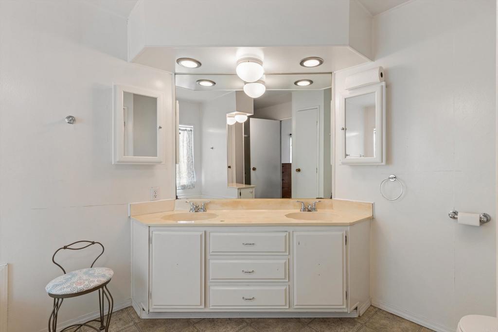 650 South Rancho Santa Fe Road, Unit 256 San Marcos, CA 92078 - Photo 20 of 60 a bathroom with a sink vanity and mirror