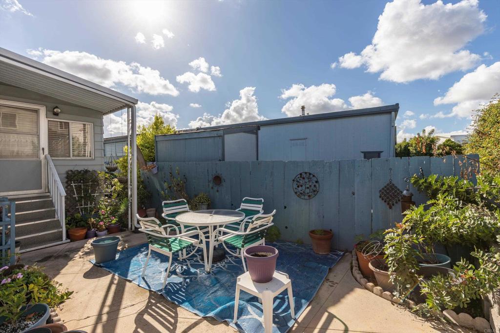 650 South Rancho Santa Fe Road, Unit 256 San Marcos, CA 92078 - Photo 29 of 60 a view of a patio with table and chairs and potted plants