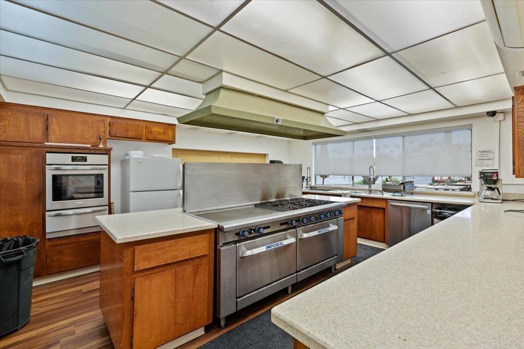 650 South Rancho Santa Fe Road, Unit 256 San Marcos, CA 92078 - Photo 57 of 60 a kitchen with stainless steel appliances granite countertop a stove a sink and a refrigerator