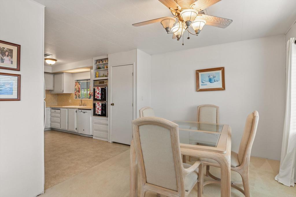 650 South Rancho Santa Fe Road, Unit 256 San Marcos, CA 92078 - Photo 7 of 60 a view of a dining room with furniture and a chandelier