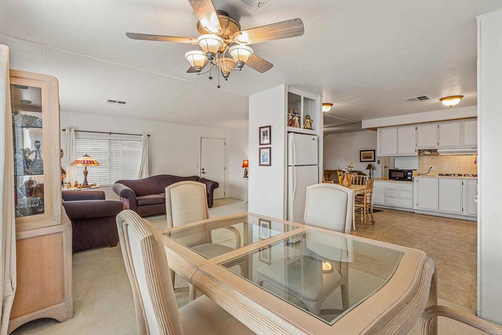 650 South Rancho Santa Fe Road, Unit 256 San Marcos, CA 92078 - Photo 8 of 60 a living room with kitchen island furniture and a view of kitchen
