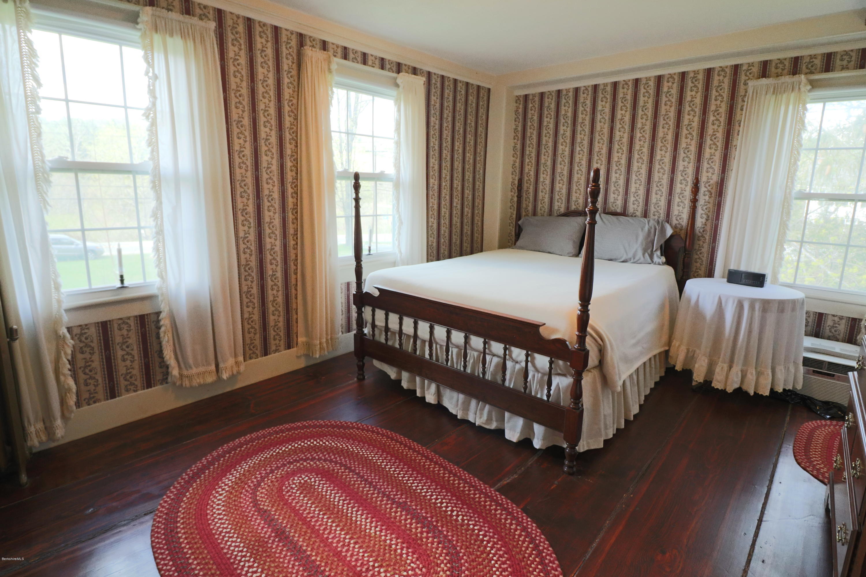 22 Summit Road Richmond, MA 01254 - Photo 40 of 52 a bedroom with a bed window and wooden floor