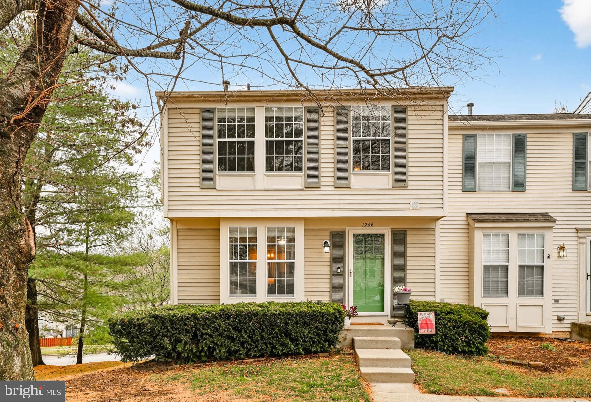 a view of a brick house with large windows
