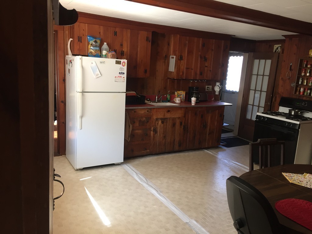 20 Killam Hill Road Boxford, MA 01921 - Photo 8 of 26 a kitchen with a refrigerator and a more cabinets