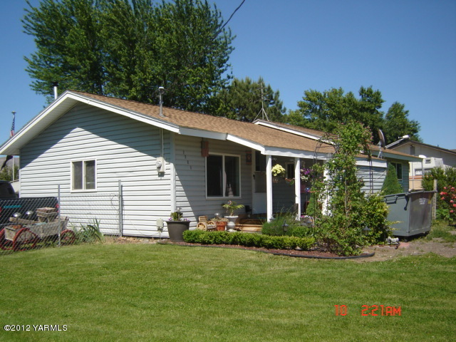 1091 Deeringhoff Road Moxee, WA 98936 - Photo 1 of 12 a front view of a house with a garden