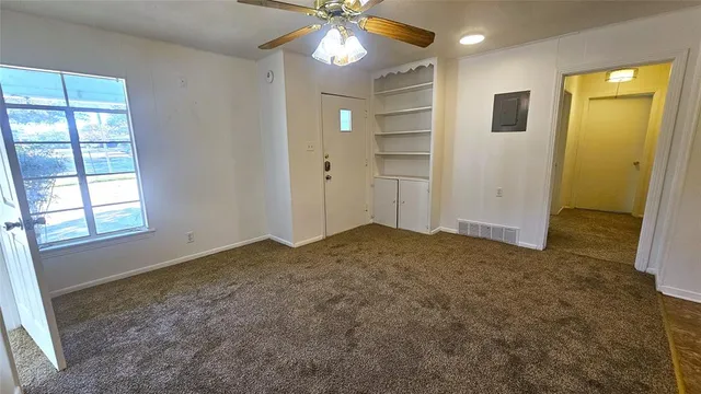 en empty room with windows and entrance