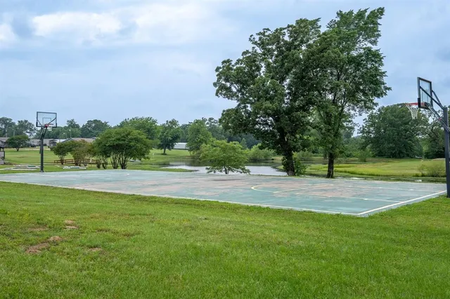a view of a swimming pool and trees in the background