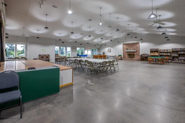 a living room with lots of furniture and a kitchen view