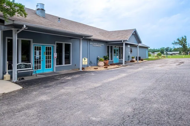 a view of a house with backyard porch and sitting area