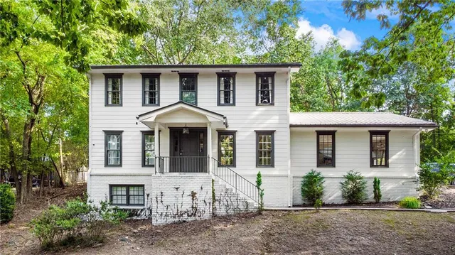 a front view of a house with garden