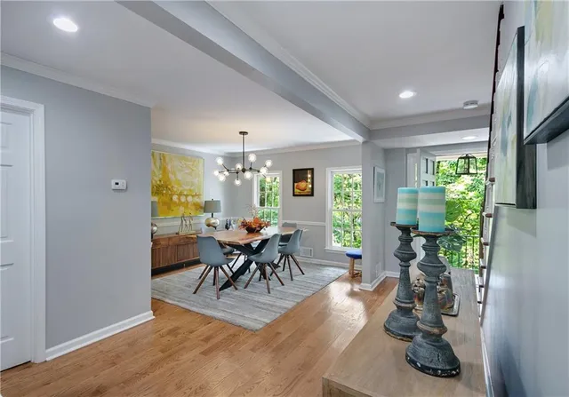 a view of a dining room with furniture and a potted plant