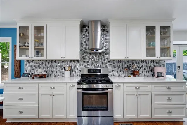 a kitchen with white cabinets and appliances