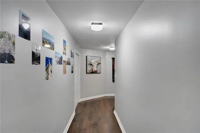 a view of a hallway with paintings on the wall
