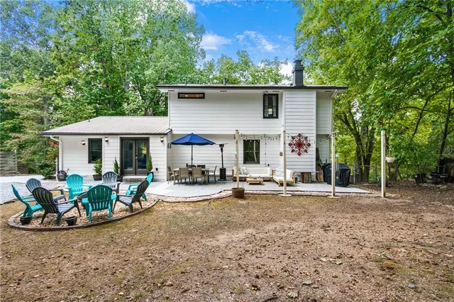 a view of a house with backyard sitting area and garden