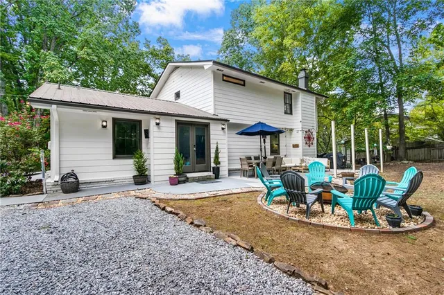 a view of a house with backyard and sitting area