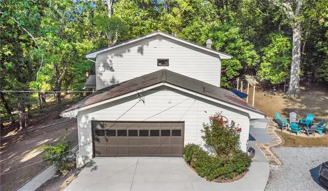 a front view of a house with a yard and potted plants