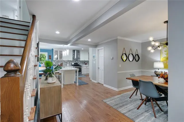 a dining room with furniture and wooden floor