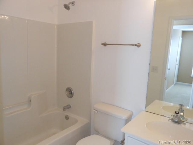 14018 Dingess Road Charlotte, NC 28273 - Photo 11 of 14 a white bath tub sitting next to a white toilet