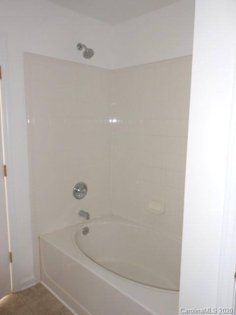 14018 Dingess Road Charlotte, NC 28273 - Photo 12 of 14 a bathroom with a bathtub