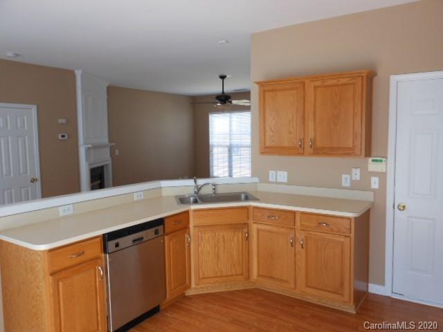 14018 Dingess Road Charlotte, NC 28273 - Photo 4 of 14 a kitchen with a sink and cabinets