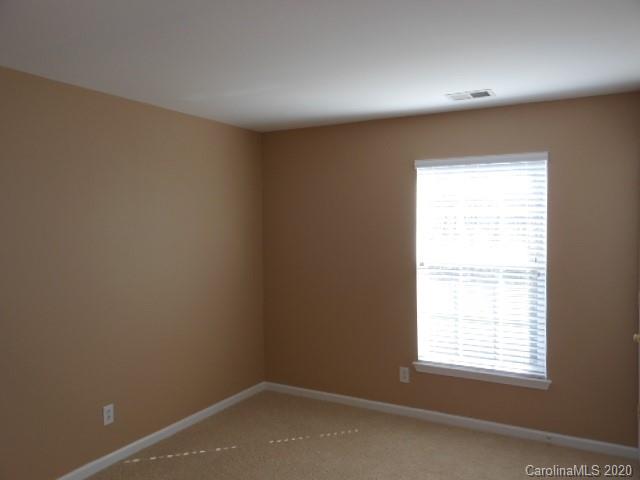 14018 Dingess Road Charlotte, NC 28273 - Photo 6 of 14 an empty room with a window
