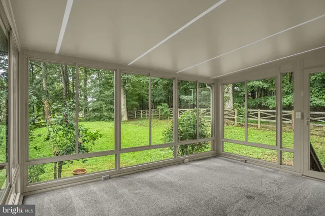 a view of a livingroom with a floor to ceiling window and an outdoor kitchen