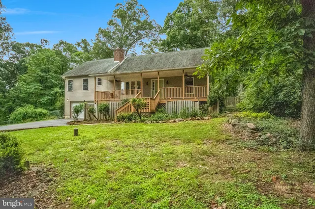 a house with green field in front of it