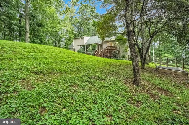 a view of a wooden deck with a yard
