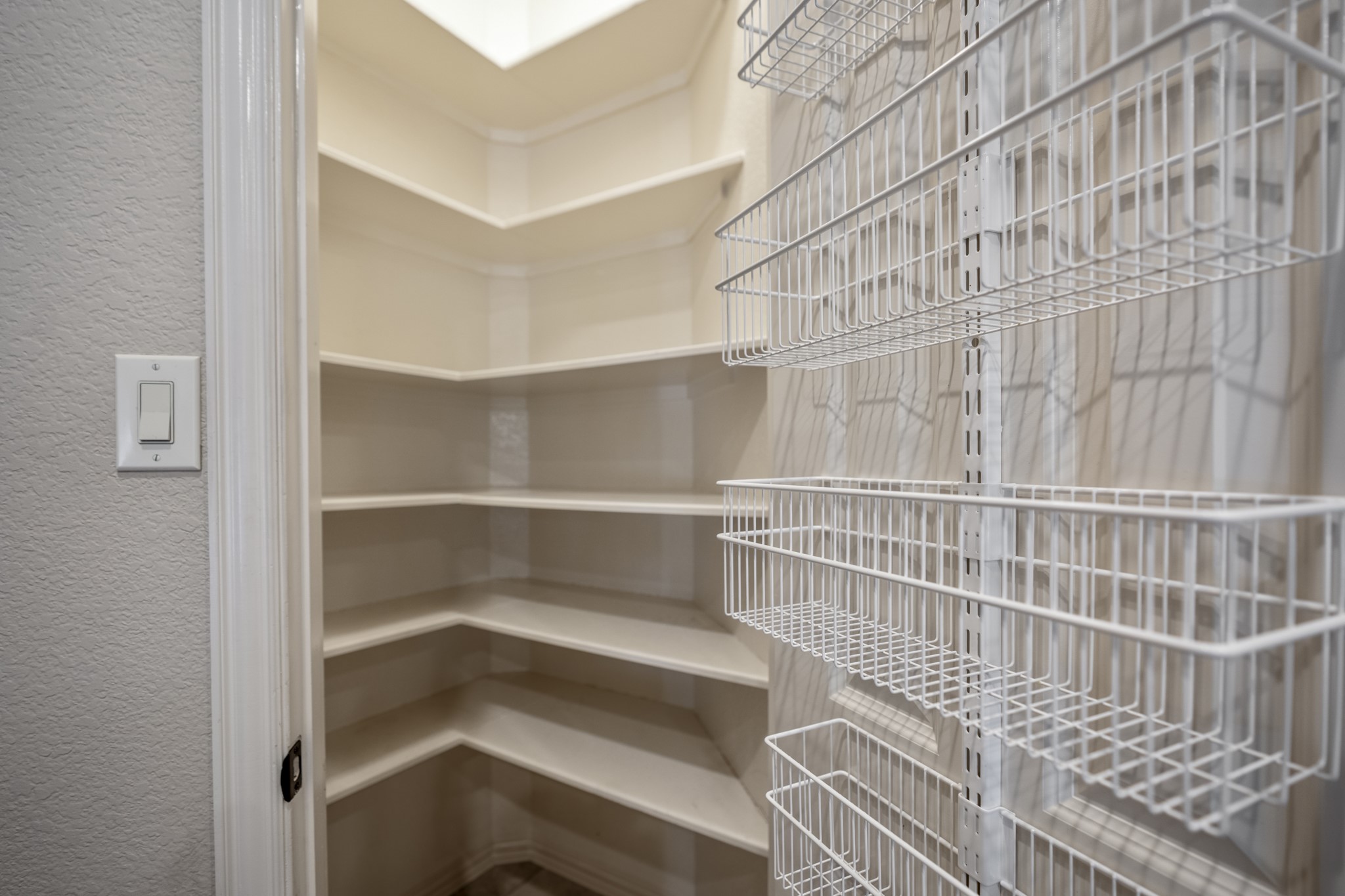 2407 Hendricks Lakes Drive Spring, TX 77388 - Photo 13 of 50 The pantry adds easy-to-reach storage with wraparound shelving and door-mounted racks for smaller items. Positioned right beside the working side of the kitchen, it keeps ingredients, serving pieces, and overflow neatly tucked away while staying close to the island, appliances, and main prep areas.
