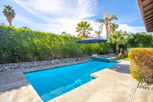 a view of a backyard with swimming pool