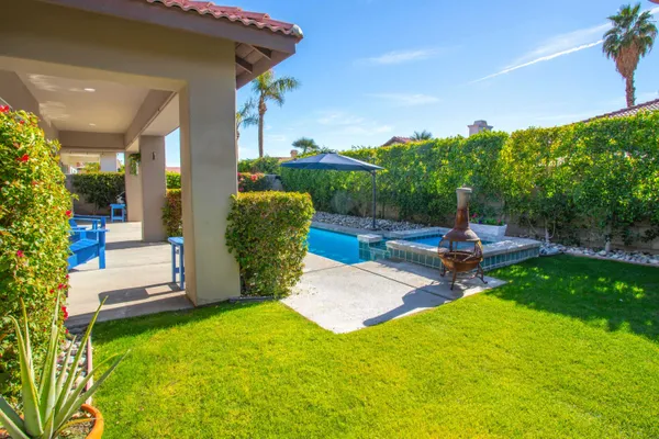 an aerial view of a house with a yard and potted plants