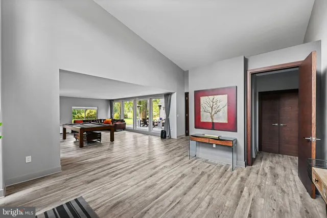 a kitchen with stainless steel appliances kitchen island granite countertop a refrigerator and a wooden cabinets