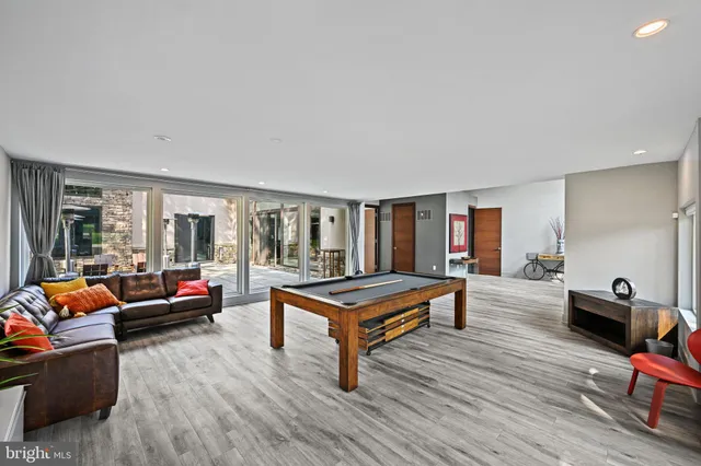 a view of a hallway with wooden floor and stairs