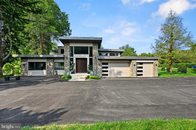 a front view of a house with a yard and a garage