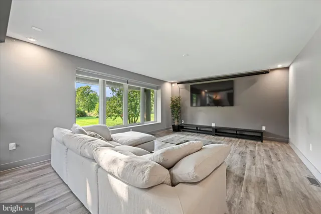 a living room with furniture and large windows