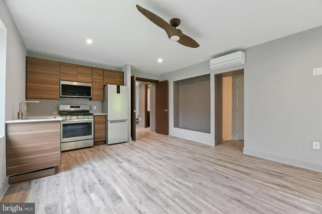 a bathroom with a shower a sink a toilet and mirror